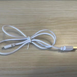 White USB cable on a wooden surface