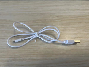 White USB cable on a wooden surface