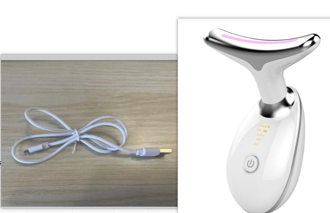 White electronic device with USB cable on a wooden surface