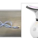White electronic device with USB cable on a wooden surface
